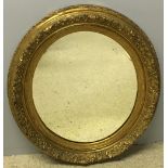 A 19th century gilt framed mirror The oval plate within acanthus scroll and floral spray border.