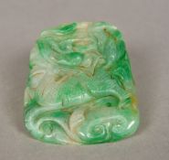 A Chinese carved green and celadon jade tablet Worked with a mythical beast. 7 cm wide.