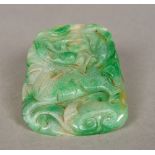 A Chinese carved green and celadon jade tablet Worked with a mythical beast. 7 cm wide.