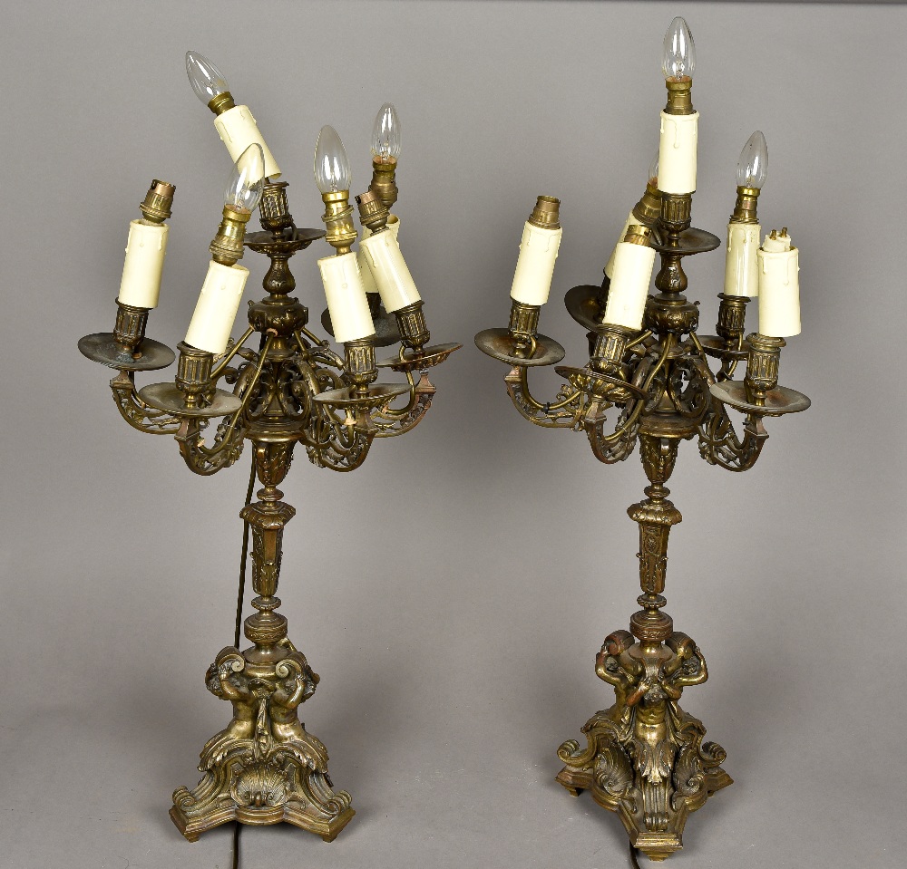 A pair of 19th century bronze candelabra Each with five scroll cast branches above the cast stem,