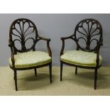A pair of early 19th century mahogany shield back open armchairs The scroll carved pierced back