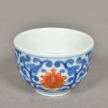 A miniature Chinese porcelain tea bowl Decorated with lotus strapwork,