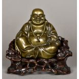 A Chinese cast bronze Buddha Modelled seated on a carved and pierced root wood throne. 21 cm high.