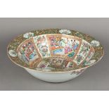 A Chinese Canton porcelain punch bowl Typically decorated with figural vignettes interspersed with