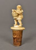 A 19th century carved ivory bottle stopper Formed as a gnome carrying a basket of wine bottles. 8.