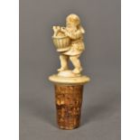 A 19th century carved ivory bottle stopper Formed as a gnome carrying a basket of wine bottles. 8.