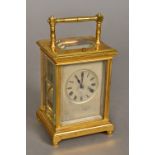 A 19th century lacquered brass cased repeating carriage clock The silvered dial with Roman numerals.