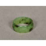 A small spinach jade ring Of band form. 8mm deep.