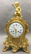 A 19th century French ormolu mantel clock The florally scroll cast case surmounted with a cherub,