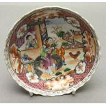 An 18th century Chinese porcelain saucer Decorated with figures in a fenced garden within landscape