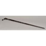 A Ceylonese ivory inlaid ebony walking stick The handle formed as an elephant mask. 87 cm long.