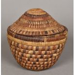 A North American Native Indian woven storage basket Of typical construction with a domed removable