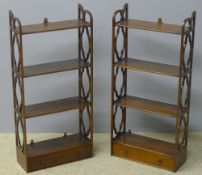 A pair of 19th century mahogany hanging shelves Each with four tiers above a base drawer and
