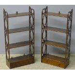 A pair of 19th century mahogany hanging shelves Each with four tiers above a base drawer and