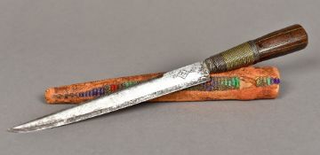 A 19th century Eastern dagger The wire inlaid and over set carved wooden handle,