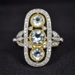 An Art Deco style 18K gold, diamond and aquamarine ring Of pierced rounded rectangular form,