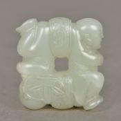 A Chinese carved white jade Four Boys pendant 3.5 cm wide.