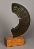 A 20th century patinated bronze abstract sculpture Of reeded curved form,
