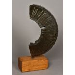 A 20th century patinated bronze abstract sculpture Of reeded curved form,