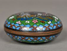 A small Japanese cloisonne box and cover Of domed form, decorated with birds amongst floral sprays.