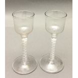 A pair of 18th century cordial glasses Each with bucket bowl and opaque twist stem. 14.5 cm high.