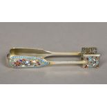 A pair of Russian enamel decorated silver tongs, mark indistinct With scrolling floral decorations.