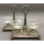 A pair of 19th century Continental silver table salts Each with twin glass reservoir and central