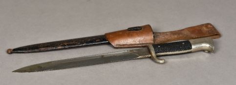 A World War II German Nazi dress bayonet Housed in original black painted metal scabbard,