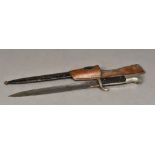 A World War II German Nazi dress bayonet Housed in original black painted metal scabbard,