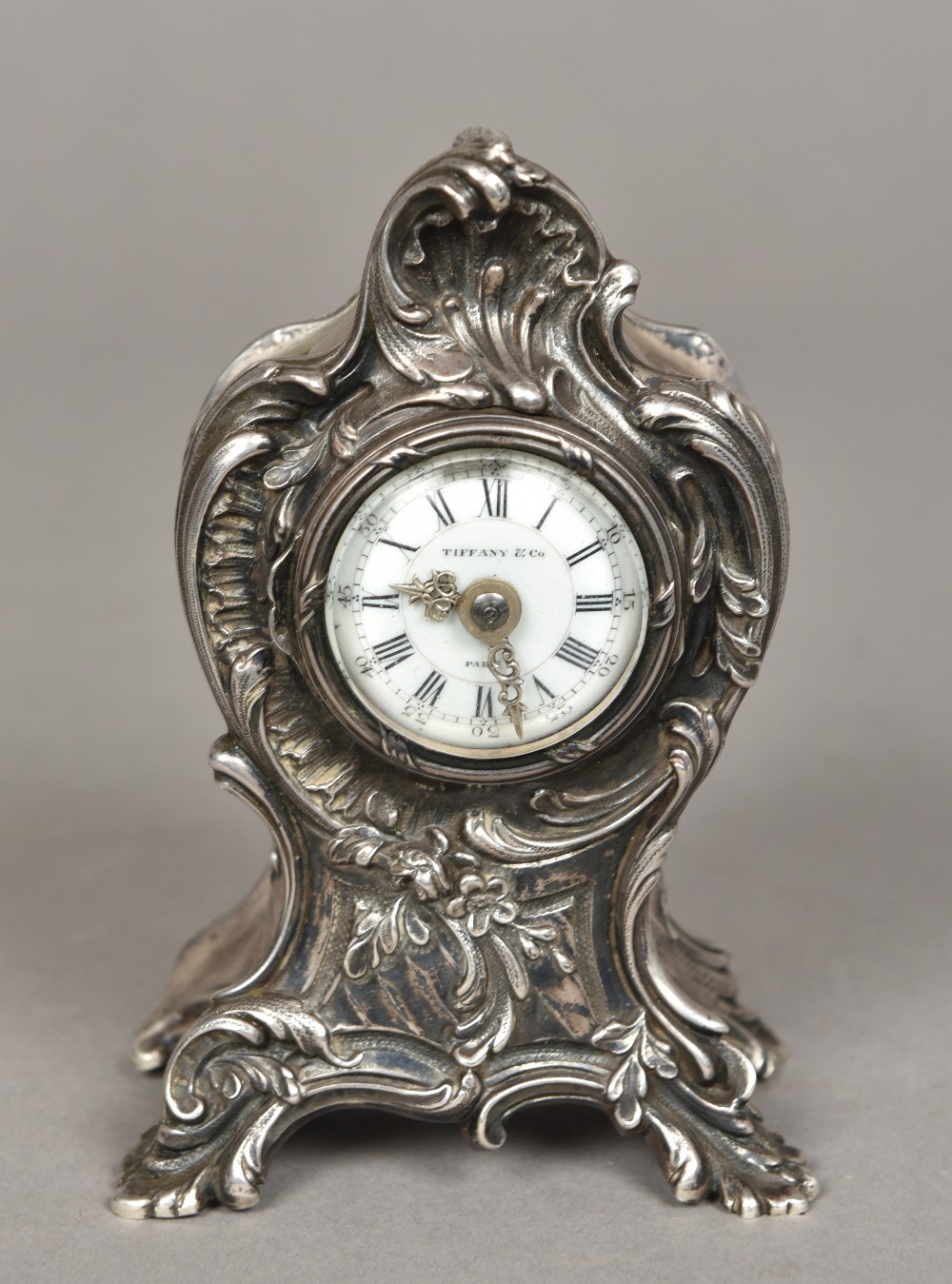 An unmarked silver cased Tiffany desk clock The case of scrolling rococo form,