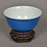 A Chinese porcelain bowl Incised with dragons chasing flaming pearls above stylised waves and with