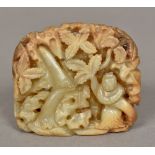 A Chinese carved white and russet jade boulder Worked with a figure beside and waterfall.