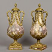 A pair of ormolu mounted carved marble baluster vases and covers Each with twin handles modelled as