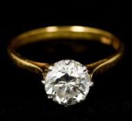 An 18 ct gold platinum and diamond solitaire ring The claw set stone spreading to approximately 1.