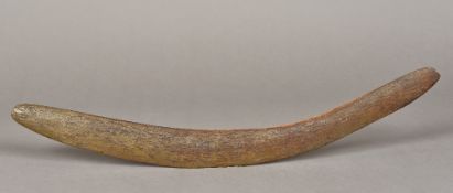 An Australian, possibly Aboriginal, carved wooden boomerang Of typical form. 59.5 cm long.