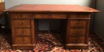 A Victorian mahogany pedestal desk The leather inset rounded rectangular top above three frieze