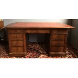 A Victorian mahogany pedestal desk The leather inset rounded rectangular top above three frieze