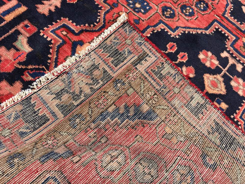 A Hamadan wool rug The midnight blue field enclosing a central cruciform medallion within stylised - Image 2 of 2