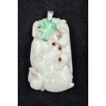 A Chinese carved green and celadon jade pendant Worked as a salamander and bat on a fruit with