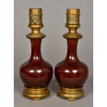 A pair of Chinese porcelain baluster vases With allover reddish/brown glaze,