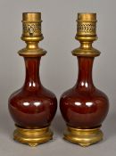 A pair of Chinese porcelain baluster vases With allover reddish/brown glaze,