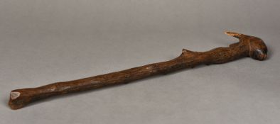 A late 19th/early 20th century Folk Art wooden club The end carved as a rabbit. 55.5 cm long.