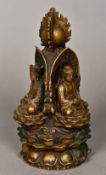 A Chinese cast bronze group Worked with three deities seated beneath a flaming pearl on a lappet