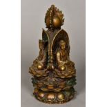 A Chinese cast bronze group Worked with three deities seated beneath a flaming pearl on a lappet