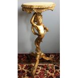 A 19th century carved giltwood torchere The column formed as a double dragon tailed putto,