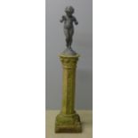 A lead cast putto Standing on a terracotta octagonal section acanthus scroll carved column,