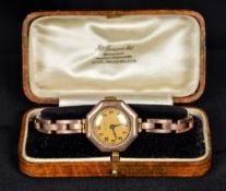 An early 20th century 9 ct gold cased lady's wristwatch Of octagonal form, with a sprung gold strap,