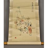 A Chinese scroll painting Decorated with playing boys and calligraphy and with red seal marks.