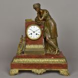 A 19th century gilt metal mounted and rouge marble figural mantel clock The white enamelled dial