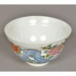A Chinese eggshell porcelain tea bowl The exterior decorated in the round with birds amongst